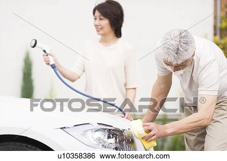 Senior couple washing car, using hose and sponge View Large Photo Image Stock Photograph - Senior couple washing car, using hose and sponge. Fotosearch
