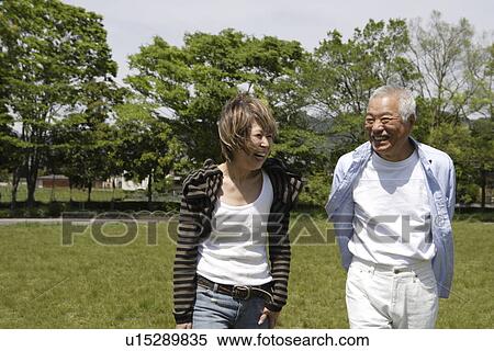 Senior man and mature woman walking in park, smiling View Large Photo Image Stock Photography - Senior man and mature woman walking in park, smiling. Fotosearch