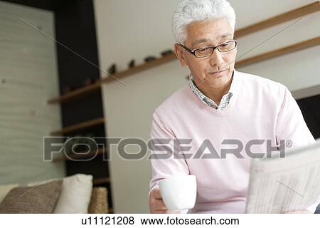 Stock Photo - Senior man reading newspaper. Fotosearch