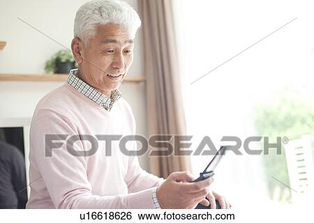 Senior man text messaging View Large Photo Image Stock Photograph - Senior man text messaging. Fotosearch