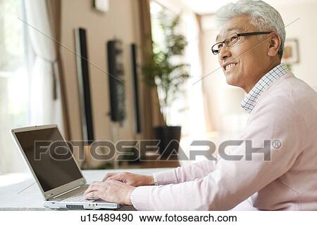 Senior man using laptop View Large Photo Image Stock Image - Senior man using laptop. Fotosearch