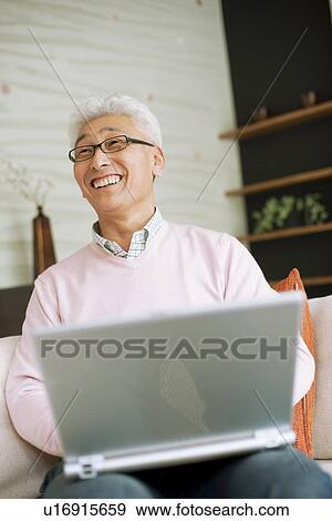 Senior man using laptop View Large Photo Image Stock Photo - Senior man using laptop. Fotosearch