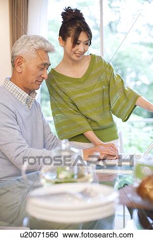 Senior man with daughter using laptop, smiling View Large Photo Image Stock Image - Senior man with daughter using laptop, smiling. Fotosearch