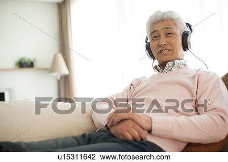 Stock Image - Senior man with headphones. Fotosearch
