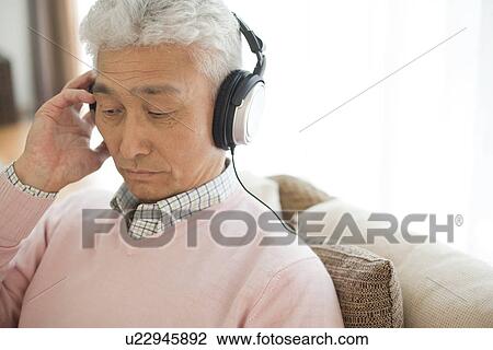 Stock Image - Senior man with headphones. Fotosearch
