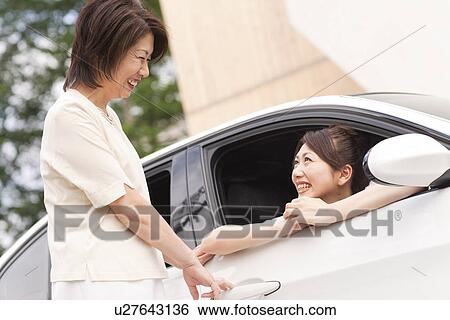 Senior woman talking to her daughter in car, smiling View Large Photo Image Stock Photograph - Senior woman talking to her daughter in car, smiling. Fotosearch