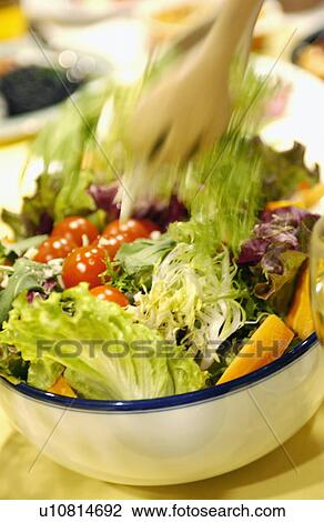 Stock Image - Serving a salad. Fotosearch