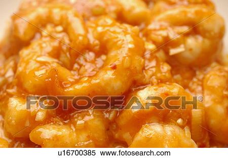 Stock Photography - Shrimps with chili sauce, close up, full frame. Fotosearch