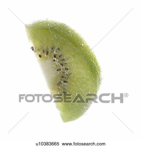 Stock Photography - Slice of kiwi in soda, close up, white background. Fotosearch