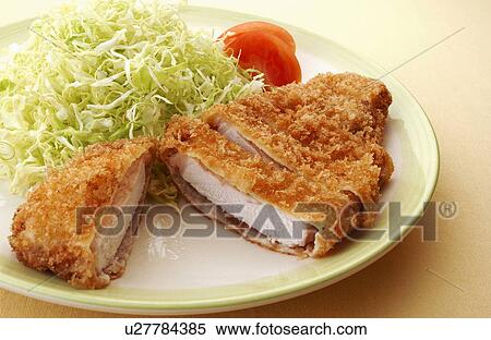 Stock Photography - Slices of deep fried pork on plate, white background. Fotosearch
