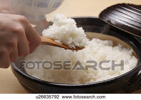 Stock Image - Steamed rice in a pot. Fotosearch