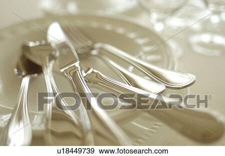 Stock Photo - Still life of plates, wineglasses and silverware. Fotosearch