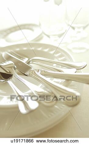 Stock Photograph - Still life of plates, wineglasses and silverware. Fotosearch