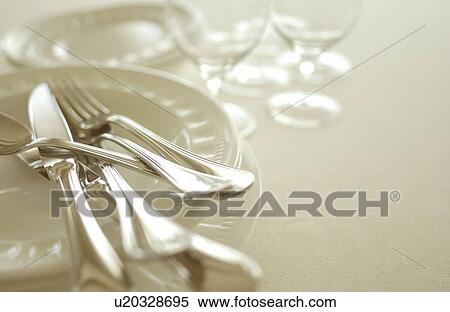 Stock Photography - Still life of plates, wineglasses and silverware. Fotosearch