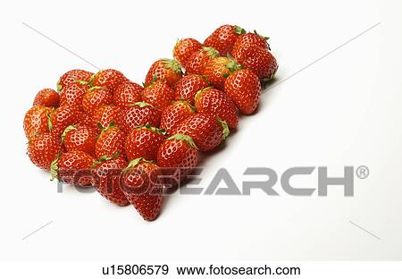 Stock Photo - Strawberries arranged in heart shape, white background, copy space. Fotosearch