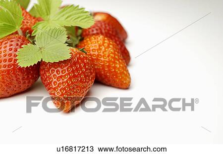 Stock Image - Strawberries on white background, close up, copy space. Fotosearch