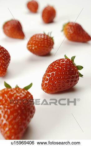 Stock Photograph - Strawberries on white background, close up. Fotosearch