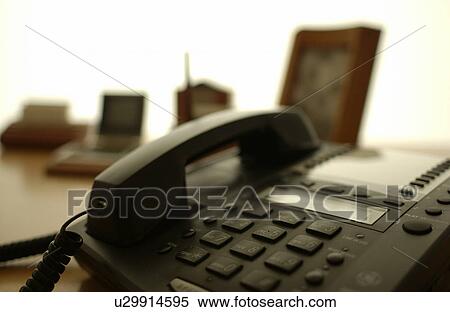 Stock Photography - Telephone on desk in office, close up, differential focus. Fotosearch