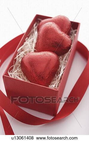 Stock Photo - Three Red Heart Chocolates in Box. Fotosearch
