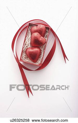 Stock Photo - Three Red Heart Chocolates in Box. Fotosearch