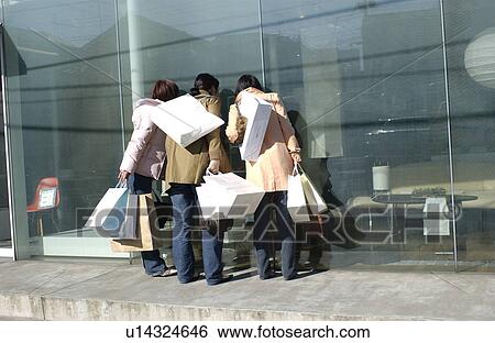 Three young women window shopping View Large Photo Image Stock Photograph - Three young women window shopping. Fotosearch