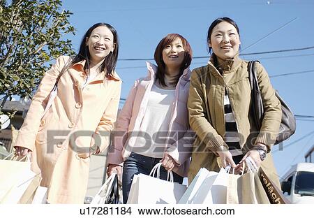 Three young women with shopping bags View Large Photo Image Picture - Three young women with shopping bags. Fotosearch