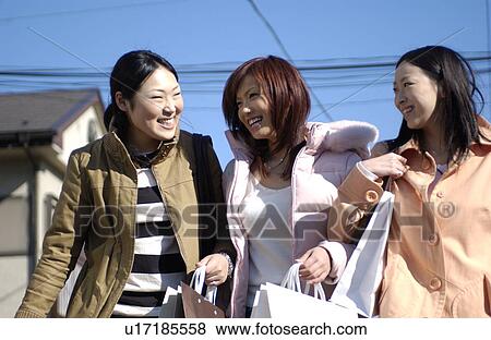 Three young women with shopping bags View Large Photo Image Stock Photo - Three young women with shopping bags. Fotosearch