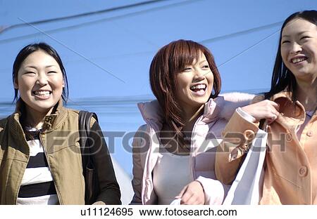 Three young women with shopping bags View Large Photo Image Stock Photography - Three young women with shopping bags. Fotosearch