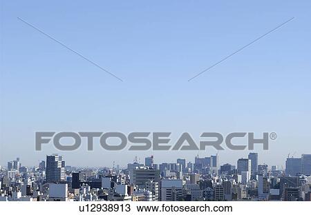 Stock Image - Tokyo cityscape under sky, copy space, Tokyo prefecture, Japan. Fotosearch