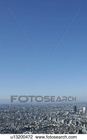 Stock Image - Tokyo cityscape under sky, copy space, Tokyo prefecture, Japan. Fotosearch