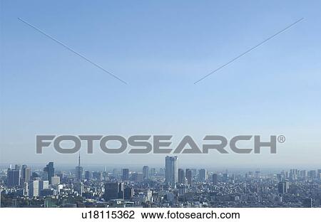 Stock Image - Tokyo cityscape under sky, copy space, Tokyo prefecture, Japan. Fotosearch