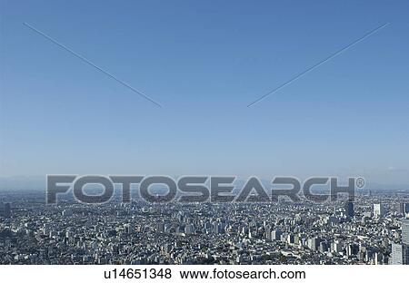 Stock Photo - Tokyo cityscape under sky, copy space, Tokyo prefecture, Japan. Fotosearch