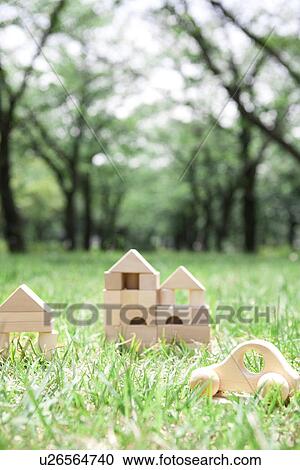 Toy car and wooden houses on grass View Large Photo Image Stock Image - Toy car and wooden houses on grass. Fotosearch