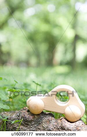 Toy car on tree trunk, differential focus View Large Photo Image Stock Photo - Toy car on tree trunk, differential focus. Fotosearch
