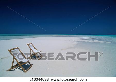 Stock Image - Two deck chairs on beach. Fotosearch