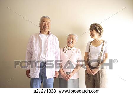 Two generation family, smiling, white background View Large Photo Image Stock Image - Two generation family, smiling, white background. Fotosearch