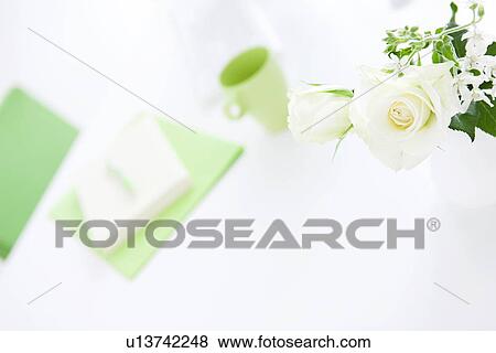 Stock Photo - Vase of white roses on desk in office, differential focus. Fotosearch