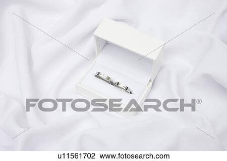 Stock Image - Wedding rings in a box. Fotosearch