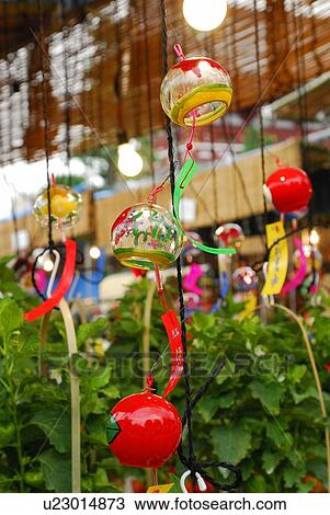 Stock Image - Wind chimes and potted winter cherries, Tokyo prefecture, Japan. Fotosearch