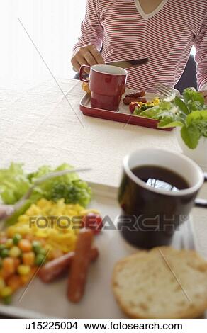 Picture - Woman Eating Breakfast. Fotosearch