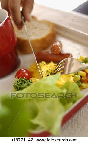 Stock Image - Woman Eating Breakfast. Fotosearch