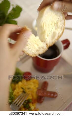 Stock Image - Woman Eating Breakfast. Fotosearch