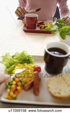Stock Photo - Woman Eating Breakfast. Fotosearch