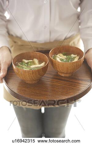 Woman holding miso soup on tray View Large Photo Image Stock Photography - Woman holding miso soup on tray. Fotosearch