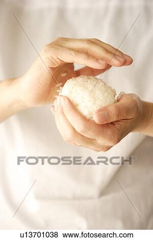 Woman making rice ball (Onigiri) View Large Photo Image Stock Photo - Woman making rice ball (Onigiri). Fotosearch