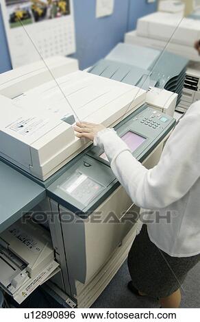 Stock Photograph - Woman Standing at Copy Machine. Fotosearch