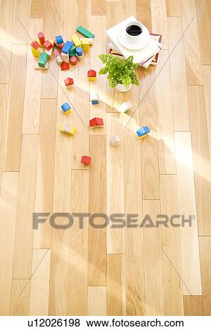 Stock Photo - Wooden blocks and cup of coffee on floor. Fotosearch