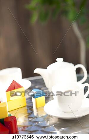 Wooden blocks and cups of coffee on table View Large Photo Image Stock Photograph - Wooden blocks and cups of coffee on table. Fotosearch