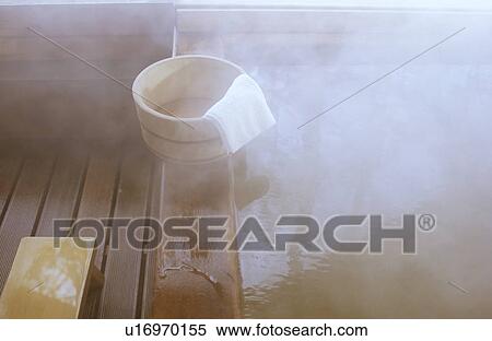 Stock Photography - Wooden bucket on bathtub. Fotosearch