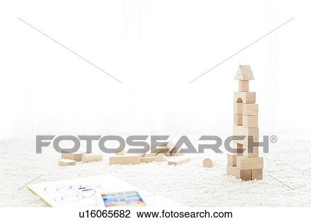 Stock Image - Wooden building blocks and sketch pad. Fotosearch